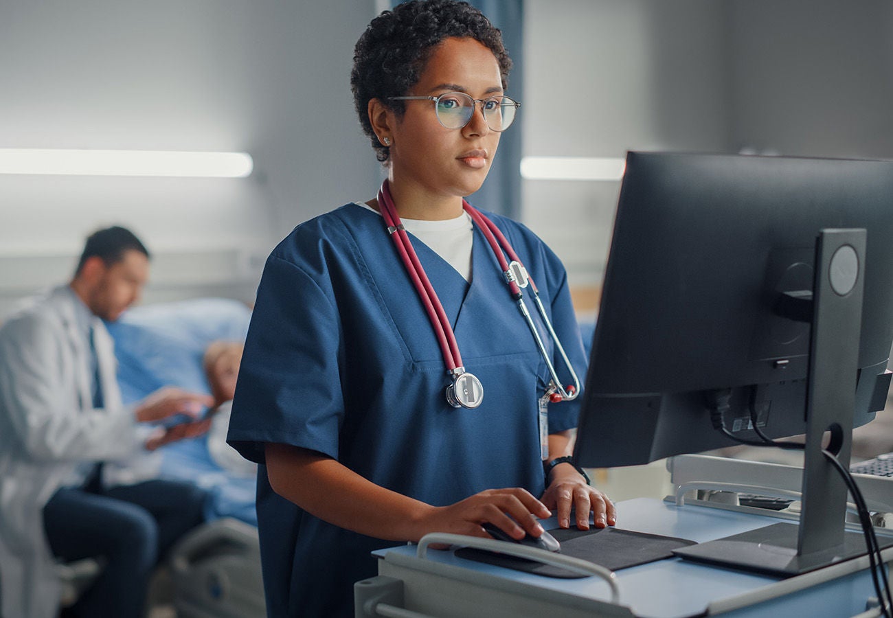 Nurse digitally communicating with primary care doctor for patient information