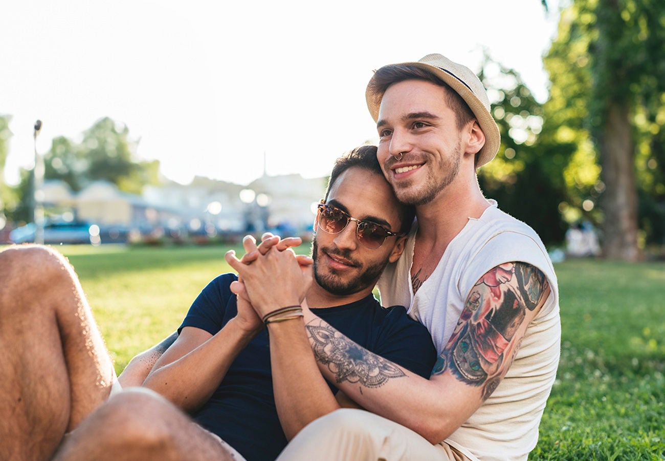 A gay couple spend time together in a park.