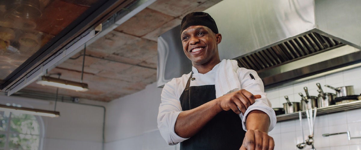 a chef rolling up his sleeves