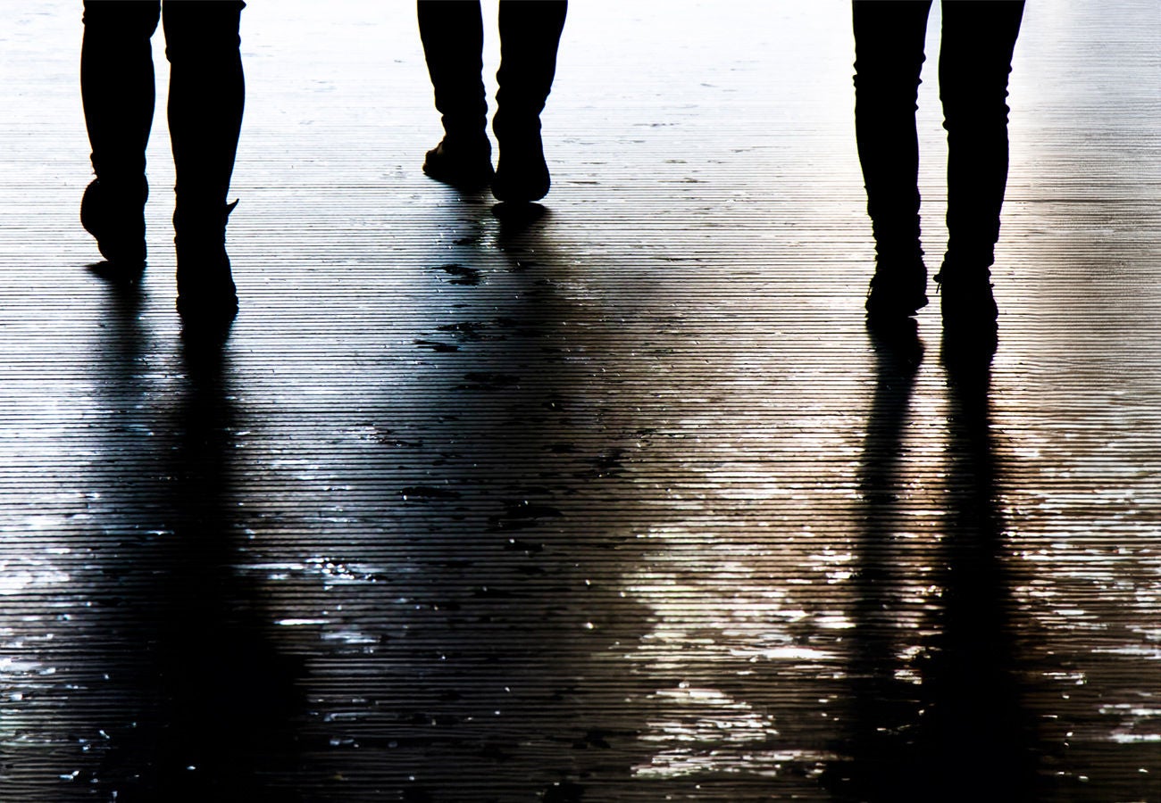 Three people walking along the street.