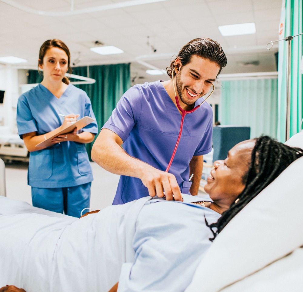 Young male physician checking on a patient