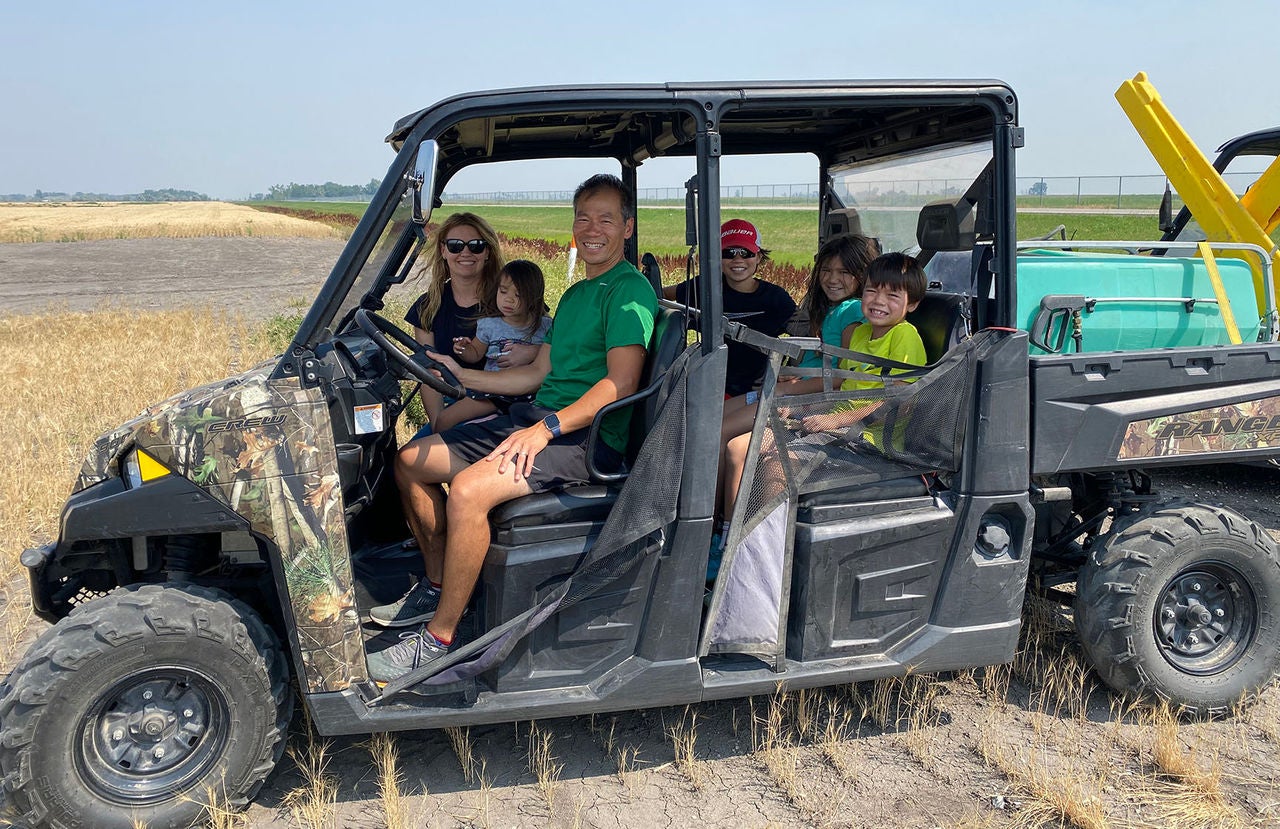 Slalom General Manager Binh Diep and family sitting in an ATV. 