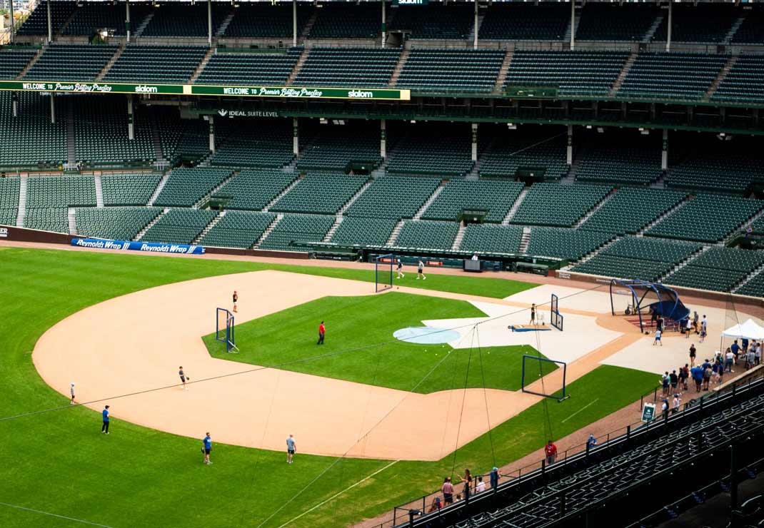 A seat view looking at the baseball field at the Chicago Cubs stadium.