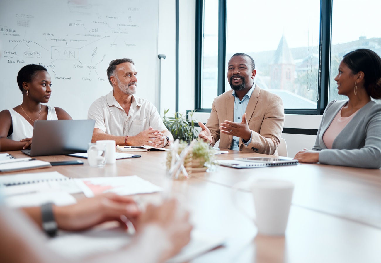 A team of employees works together in a meeting.