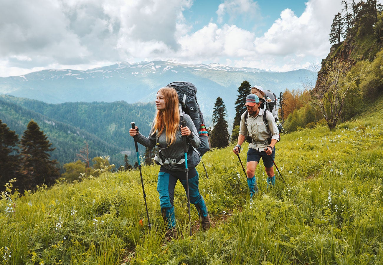 Couple hiking together in a montain field.