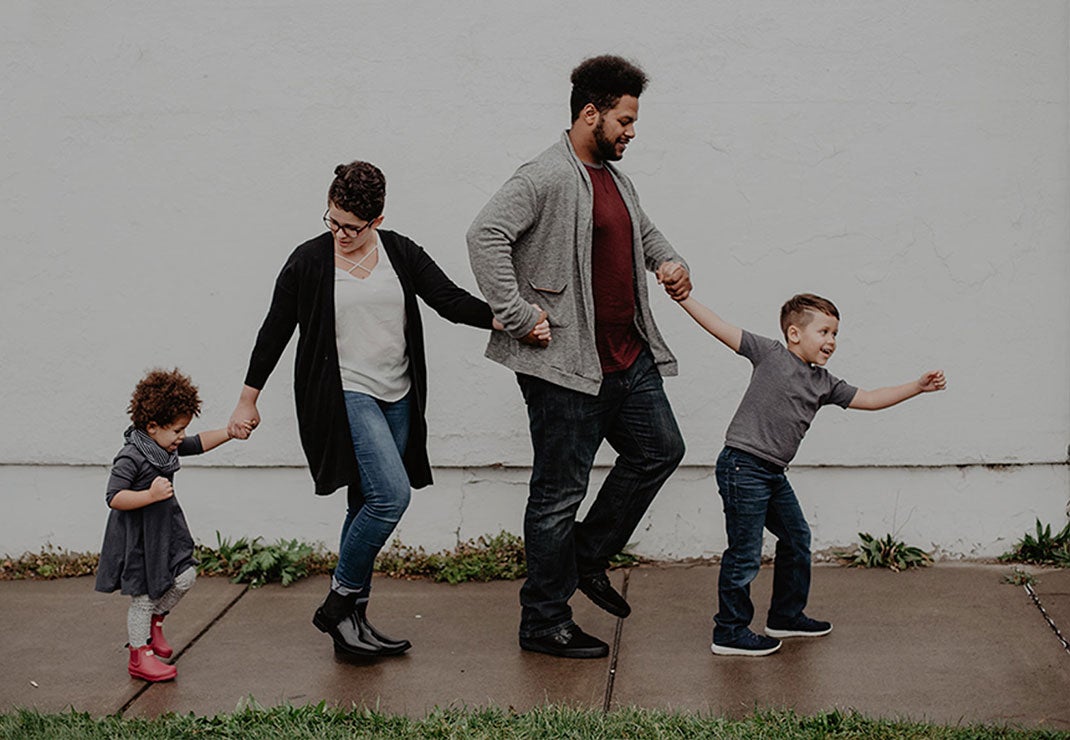 family walking down the sidewalk