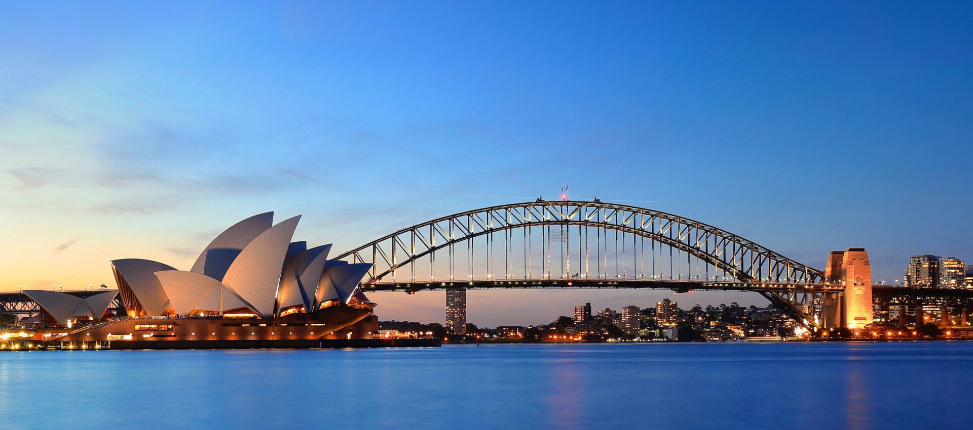 The sunsets on the harbor and opera house in Sydney.