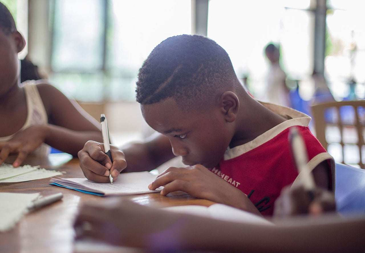 Child in a classroom working on an assignment.