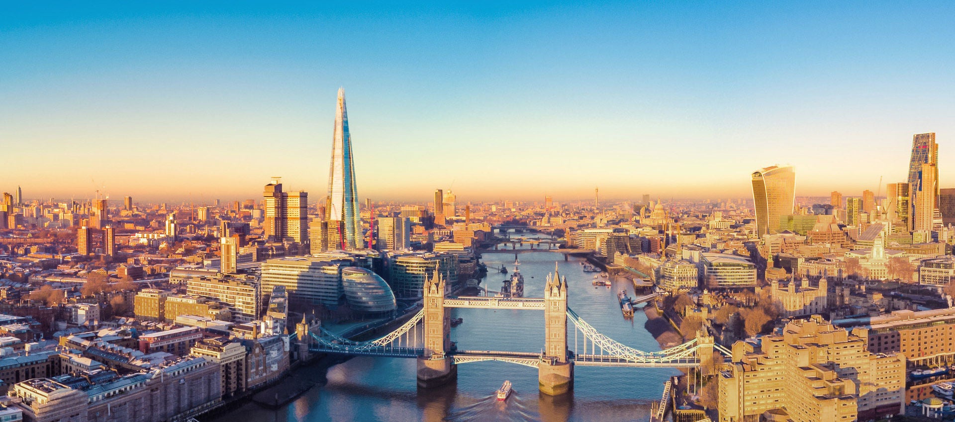 The Tower Bridge is seen as it spams the River Thames on a sunny evening in London.