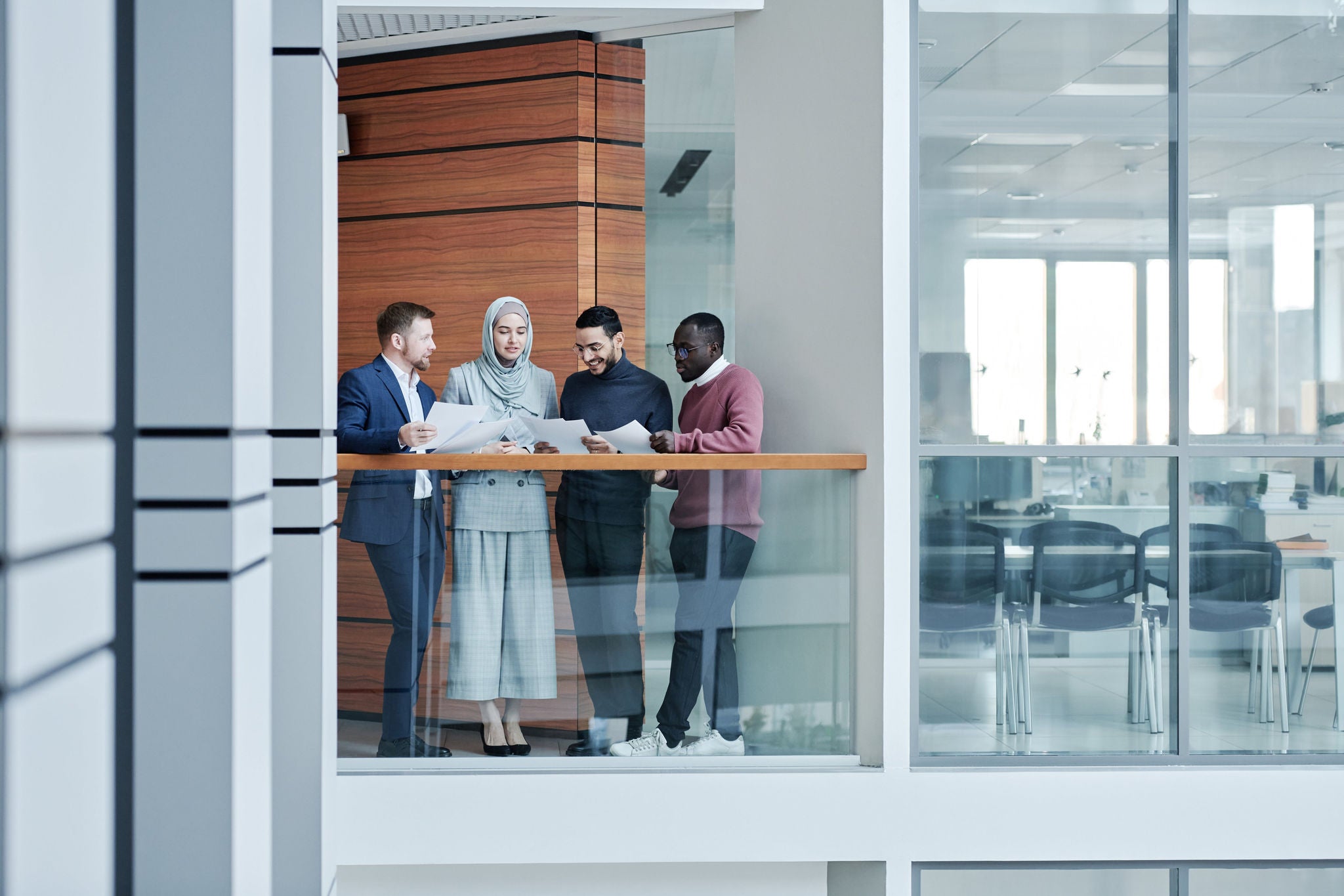 team of four meets in hallway