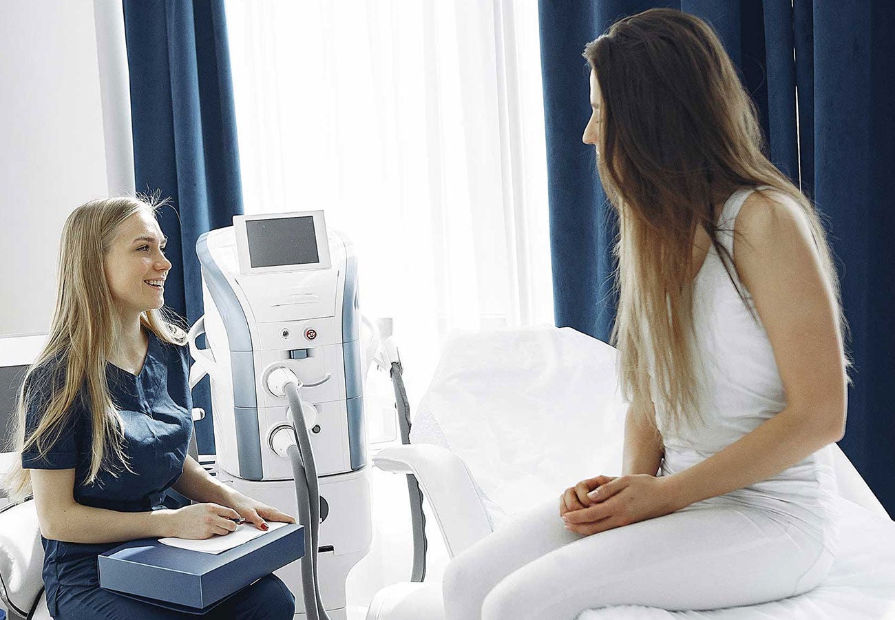 Woman in an exam room at a doctor's office.