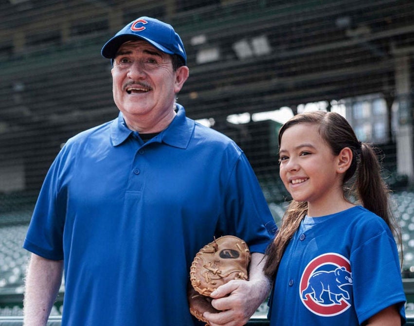 Grandfather and granddaughter Chicago Cubs fans.