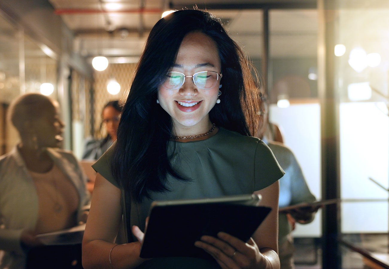 A woman uses a tablet in the office.