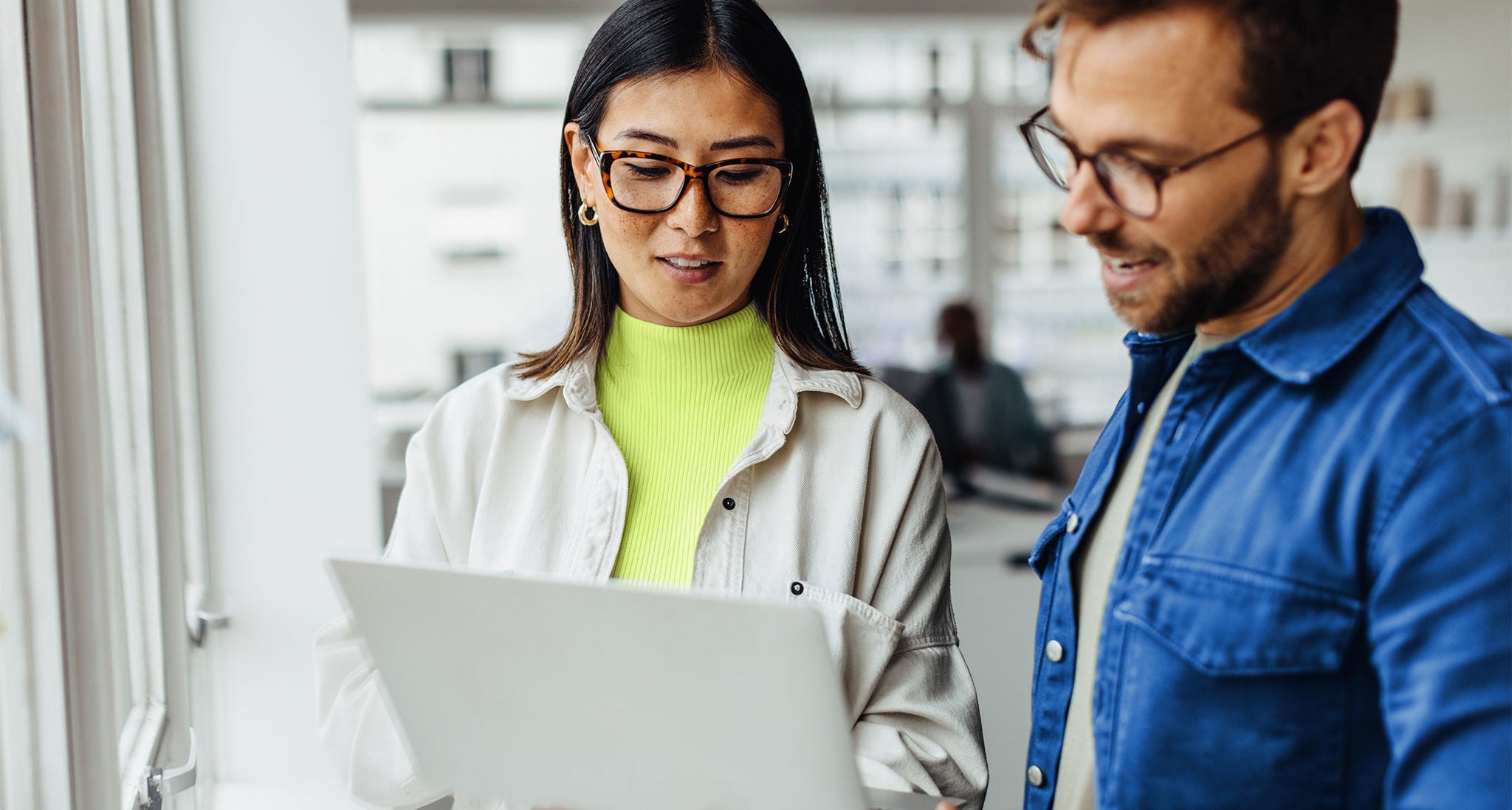 Employees reviewing generative AI highlights on a tablet