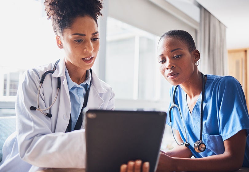 Tablet, black people or nurses reading news, medical research or tests results in hospital together. Teamwork, digital media or African doctors planning or speaking of healthcare report on website.