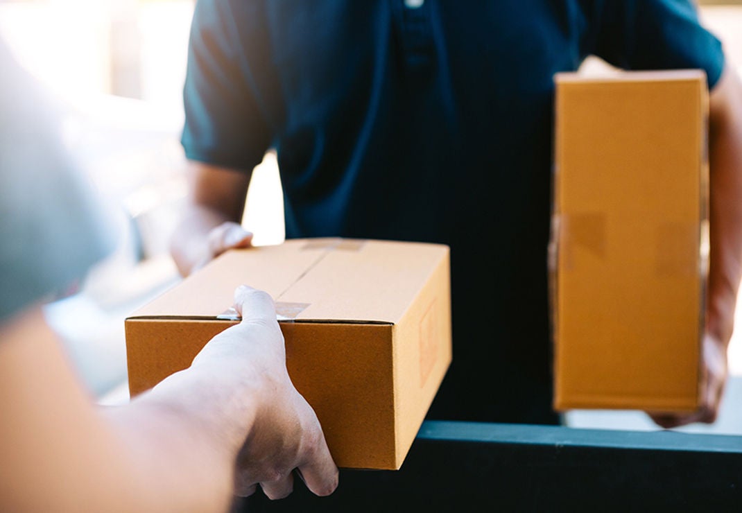 Boxes being delivered and handed to another person.