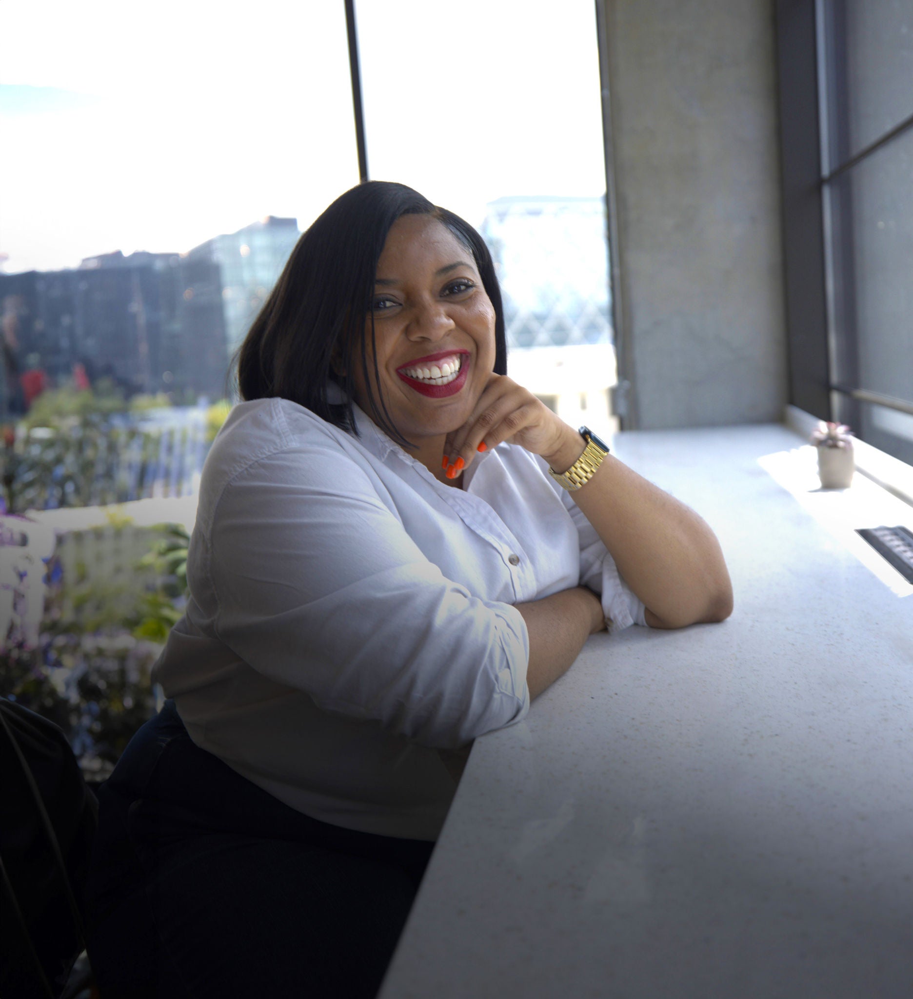 Slalom employee Jenae looks at the camera while in the office.