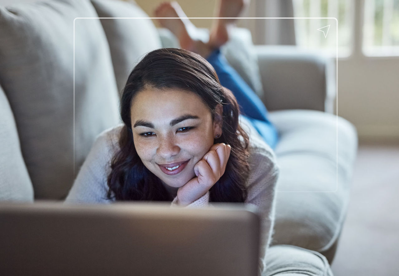 person looking at laptop on couch